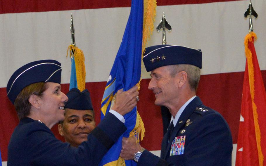 Lt. Gen. Terrence J. O'Shaughnessy receives the 7th Air Force banner from Gen. Lori J. Robinson, Pacific Air Forces commander, during an assumption-of-command ceremony at Osan Air Base, South Korea, on Friday, Dec. 19, 2014. O'Shaughnessy's previous assignment was the director of operations for Pacific Command, at Camp H.M. Smith, Hawaii. 