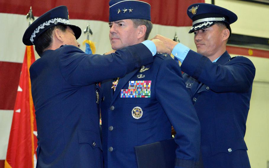 Outgoing 7th Air Force commander Lt. Gen. Jan-Marc Jouas receives a South Korean military decoration during an assumption-of-command ceremony at Osan Air Base, South Korea, on Friday, Dec. 19, 2014. Jouas is set to retire from the Air Force in February. 