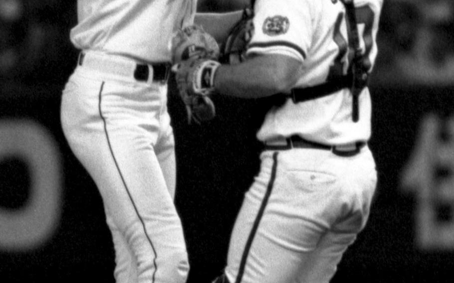 Randy Johnson and catcher Greg Olson celebrate after the final out of the no-hitter.