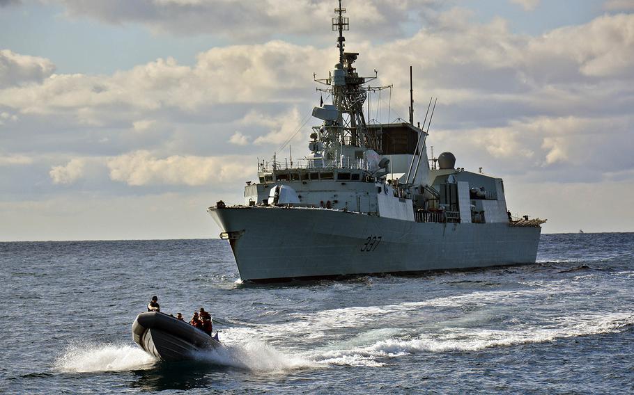 A rigid-hull inflatable boat from the Standing NATO Maritime Group 2 flagship guided-missile cruiser USS Vicksburg departs HMCS Fredericton during a sailor exchange between the U.S. and Canadian ships on Feb. 11, 2015. International warships assigned to the U.S.-led NATO maritime group entered the Black Sea on Wednesday, March 4, 2015, to train with alliance members in the region.