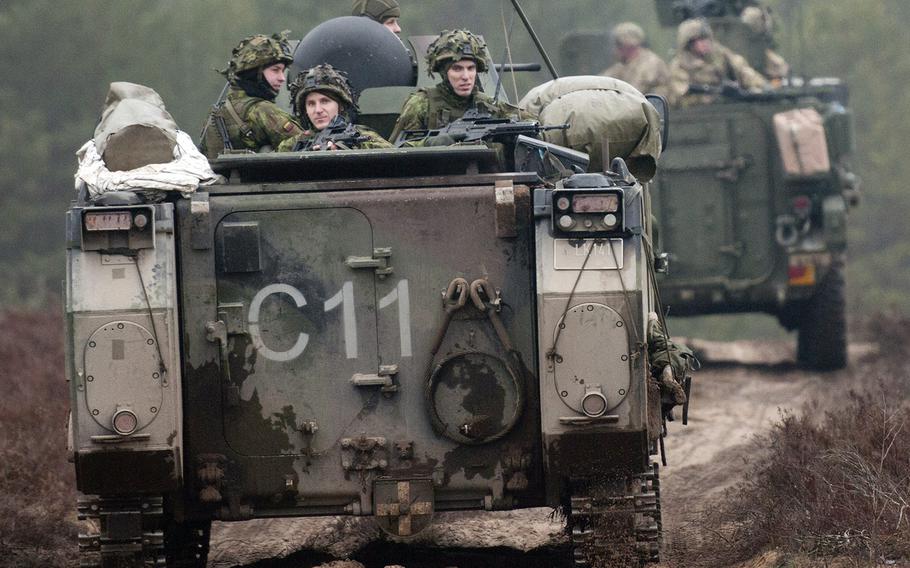 Lithuanian soldiers (left) from 3rd Company, Algirdas Mechanized Infantry Battalion, in a M113 armored personnel carrier, follow U.S. Troopers from 3rd Platoon, Lightning Troop, 3rd Squadron, 2nd Cavalry Regiment, in a Stryker during a live-fire joint training exercise in support of Operation Atlantic Resolve, at Pabrade Training Area, Lithuania, March 2, 2015.