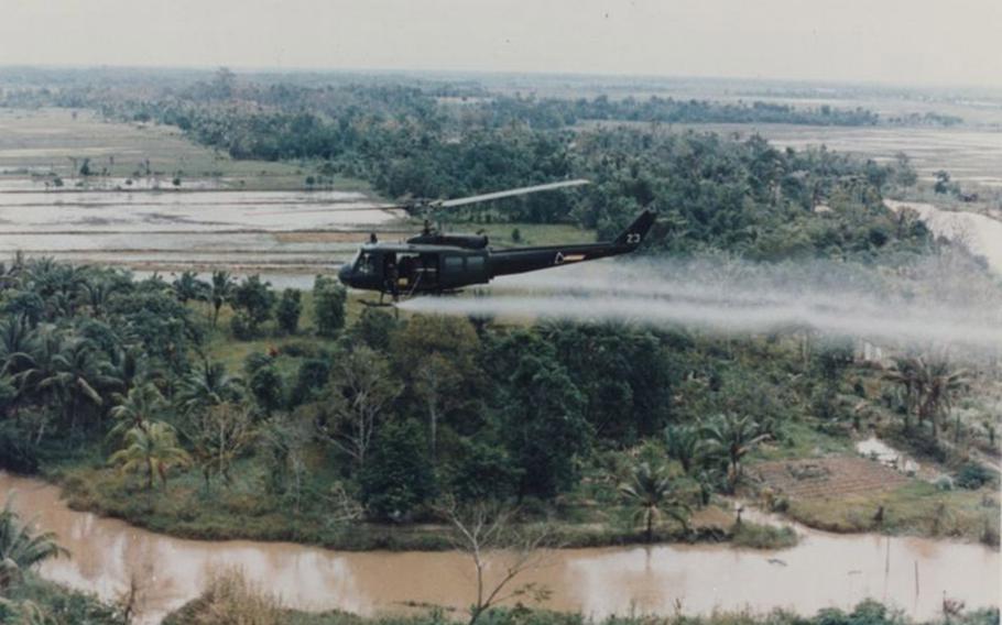 A U.S. military helicopter sprays Agent Orange over Vietnam in this undated photo from the war. 