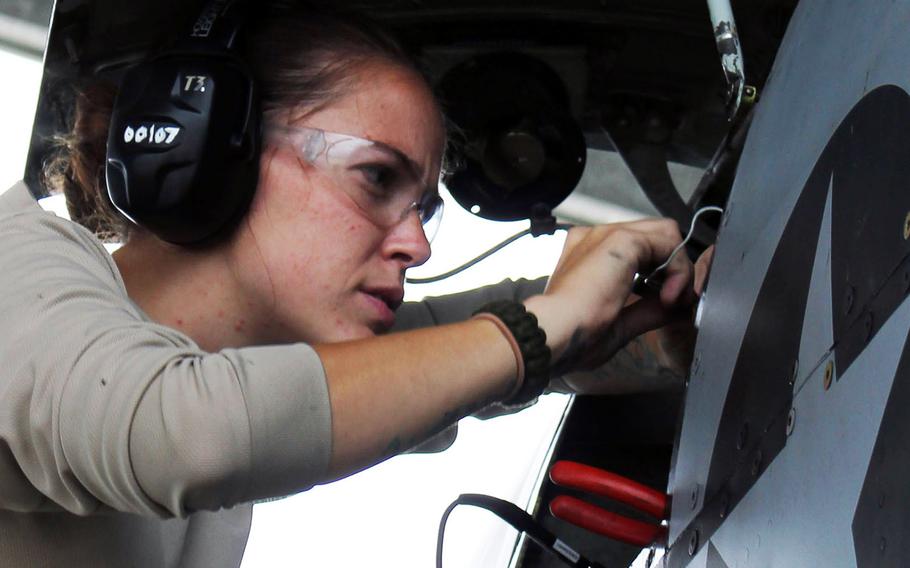 U.S. Air Force Staff Sgt. Nicole Moss, assigned to the 127th Wing, Michigan Air National Guard, performs routine maintenance on an A-10 Thunderbolt II  aircraft at Selfridge Air National Guard Base, Mich., Aug. 29, 2013.