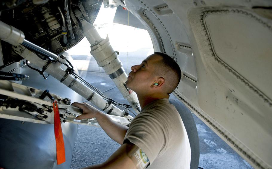 Airman 1st Class Ross Magedoff inspects components inside the landing gear of an F-16 fighter jet April 24, 2012, at Luke Air Force Base. Tactical aircraft maintainers are among career fields the Air Force is extending re-enlistment bonuses to fiscal 2015. The bonuses were effective as of March 12, 2015.