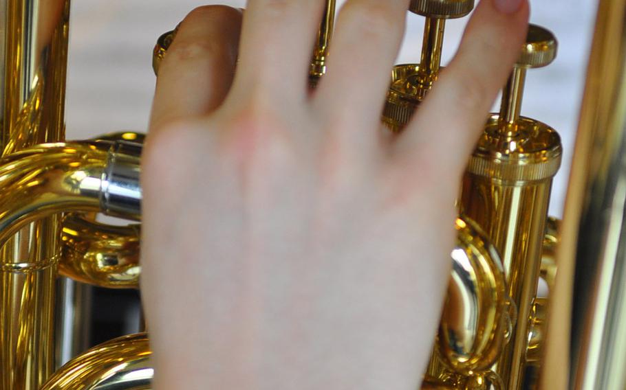Fingers move over the keys of a brass instrument during band rehearsal Tuesday at the DODDS-Europe Honors Music Festival at Oberwesel, Germany.
