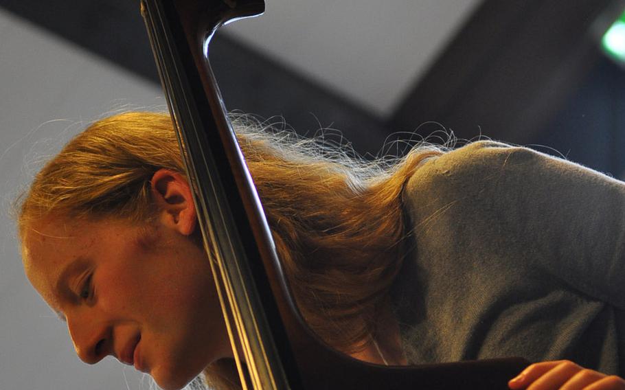 Baileigh McFall of Bitburg smiles while playing the string bass during rehearsals Tuesday, March 24, 2015, for the annual DODDS-Europe Honors Music Festival at Oberwesel, Germany.