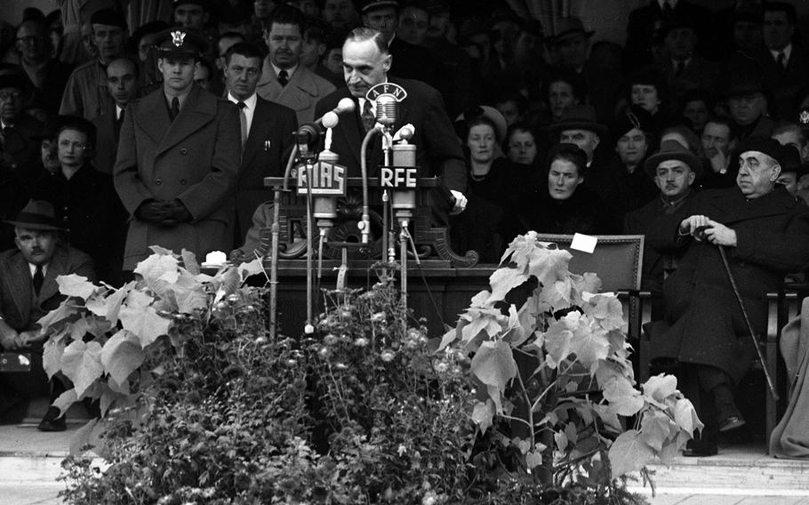 Berlin Mayor Ernst Reuter, far right, and other dignitaries listen as Gen. Lucius Clay speaks at the Freedom Bell ceremony.