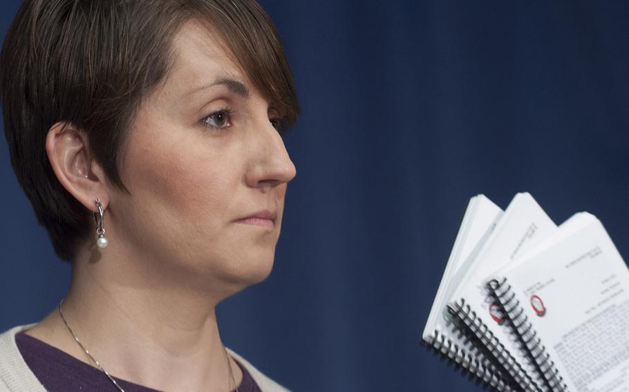 Jennifer Smith displays copies of the controversial unofficial Air Force song book as she speaks at a news conference in Washington, D.C., March 31, 2015.