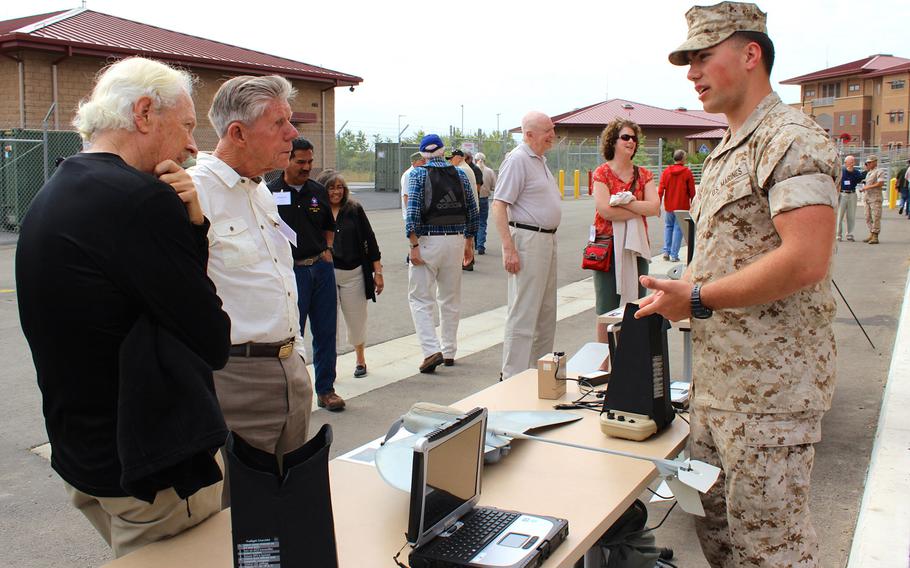 A Marine with 1st Marine Reconnaissance Battalion talks to Vietnam-era recon veterans about a drone Thursday, April 23, 2015, during a veterans' reunion event at Camp Pendleton, Calif.