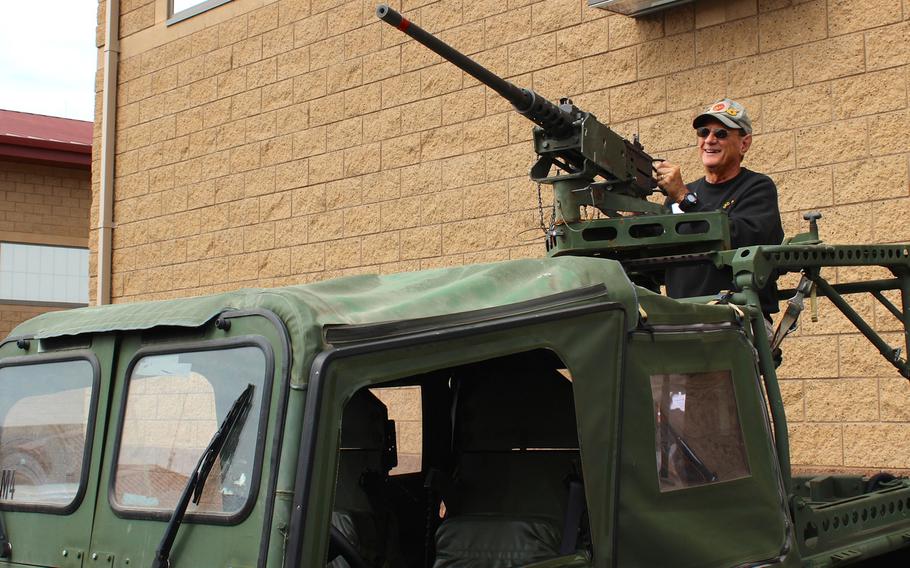 A Marine reconnaissance veteran poses with a 50-caliber machine gun mounted on an intermediate transportable vehicle Thursday, April 23, 2015, at Camp Pendleton, Calif., during a reunion for Vietnam-era vets.