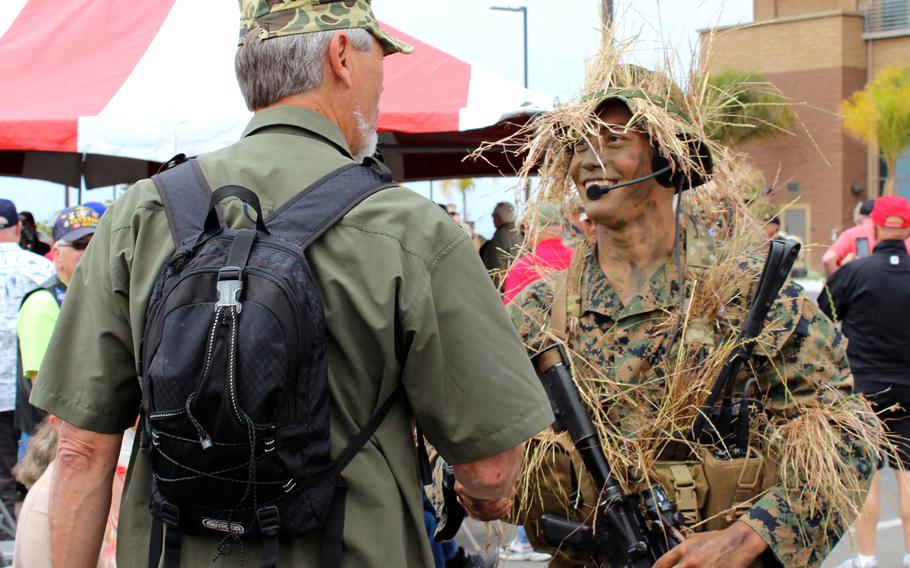 Cpl. Brandon Tan of 1st Marine Reconnaissance Battalion shakes hands with a Vietnam-era recon veteran Thursday, April 23, 2015, after a demonstration at Camp Pendleton, Calif. The veterans gathered at the base for a reunion. Tan thanked many of them for their service and the legacy they cultivated.