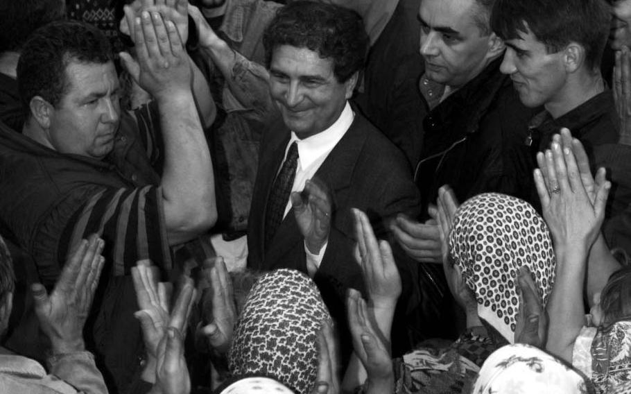 Bosnian Prime Minister Hasan Muratovic is applauded by a group of Muslims after telling them they can remain in Jusici in September, 1996.