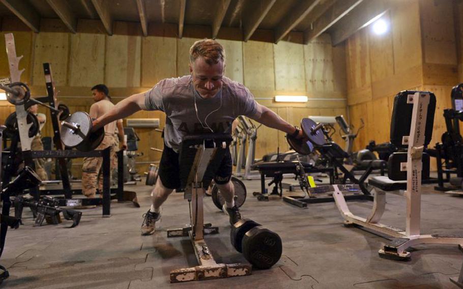 U.S. Army Spc. Ryan Bussell works out at the gym at the coalition base in Besmaya, Iraq. Like many structures at the base, the building used as a gym and recreation center dates from the last U.S. presence here before 2011.