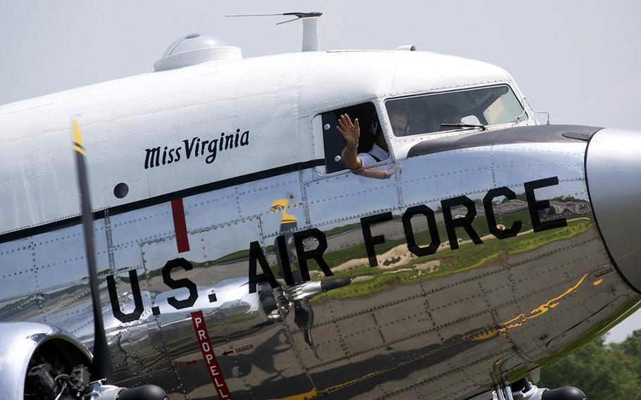 A pilot waves to the crowd after landing his plane at the Culpeper Regional Airport Thursday, May 7, during the preview for the Arsenal of Democracy: World War II Victory Capitol Flyover.