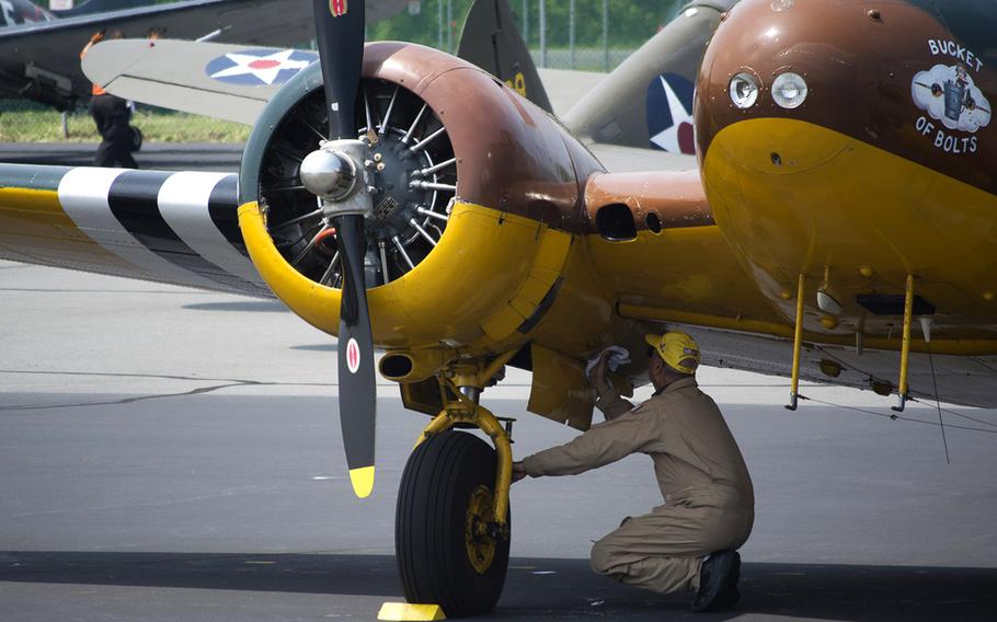 A maintaince worker cleans a plane after it landed at the Culpeper Regional Airport Thursday, May 7, during the preview for the Arsenal of Democracy: World War II Victory Capitol Flyover.