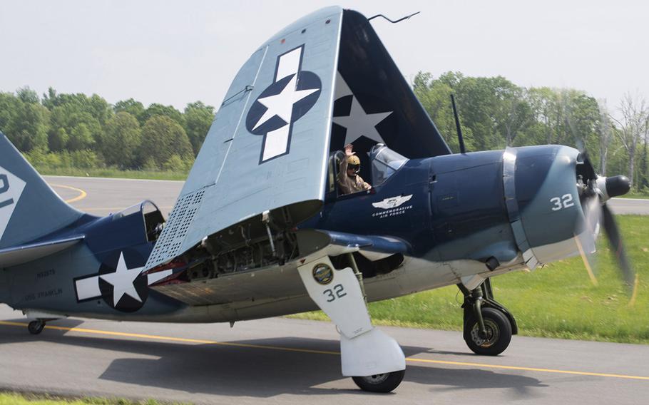 A pilot waves Thursday, May 7, 2015 in Culpeper, Va., after landing his plane at the preview for the Arsenal of Democracy: World War II Victory Capitol Flyover.
