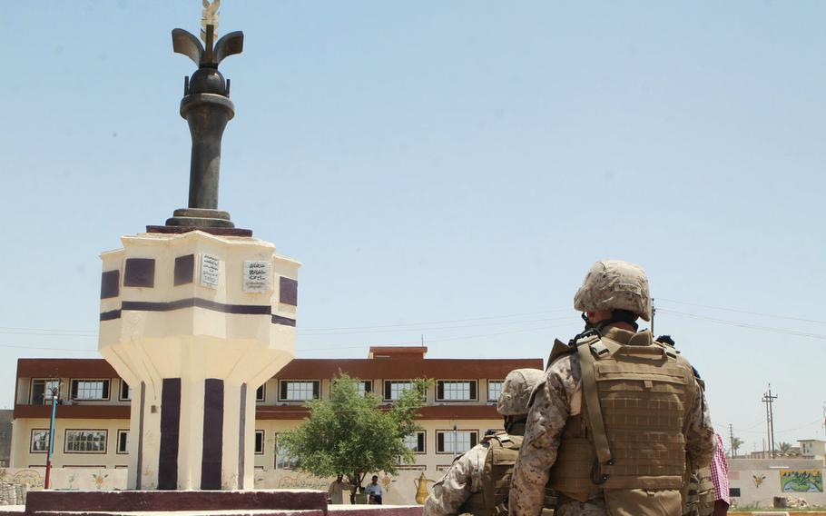 In this June 2008 photo, Marines gaze at a statue donated to the city of Ramadi by a local Iraqi contractor. The contractor built the statue in a park where a statue of Saddam Hussein once stood. The statue was meant to be a symbol of peace in Ramadi.