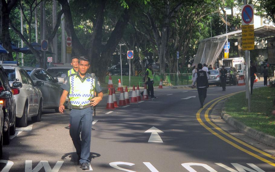 Singapore police block access to the road leading to the Shangri-La Hotel on Sunday morning, hours after one man was shot dead trying to drive through a police blockade. The hotel is hosting the Shangri-La Dialogue, a security summit including top defense officials from all over the world.

