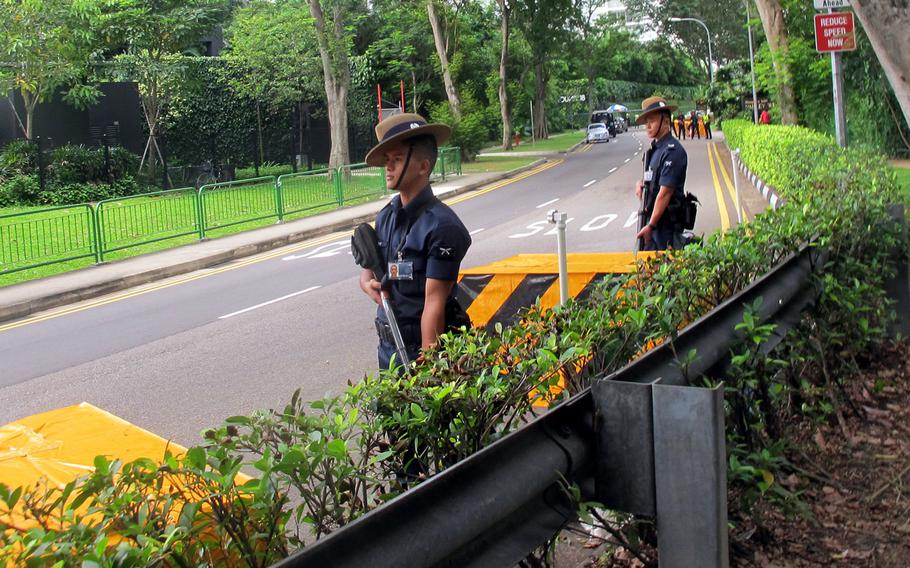 Singapore police guard the road leading to the Shangri-La Hotel on Sunday morning, hours after one man was shot dead trying to drive through a police blockade. The hotel is hosting the Shangri-La Dialogue, a security summit including top defense officials from all over the world.