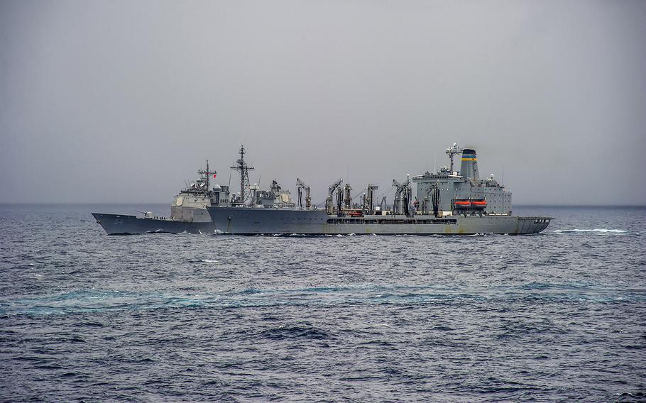 The guided missile cruiser USS Antietam (CG 54), background, steams alongside the fleet replenishment oiler USNS Walter S. Diehl (T-AO 193) during a replenishment at sea in the South China Sea June 23, 2014.  