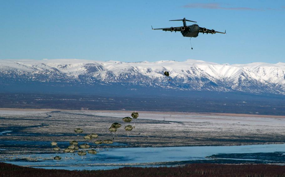 Soldiers assigned to the 725th Brigade Support Battalion, 4th Infantry Brigade Combat Team (Airborne), 25th Infantry Division, jump from an Air Force C-17 Globemaster III as part of a proficiency jump over Malemute Drop Zone, Joint Base Elmendorf-Richardson, Alaska, Feb. 27, 2014.