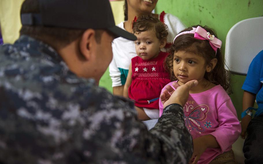 Medical Treatment Facility Command Senior Chief Aurelio Ayala, assigned to Military Sealift Command hospital ship USNS Comfort speaks with patients at a medical site established at Colon, Panama, on May 31, 2015, during a civil-military operation. Ayala was relieved of his duties July 9, 2015, following an alcohol-related incident.