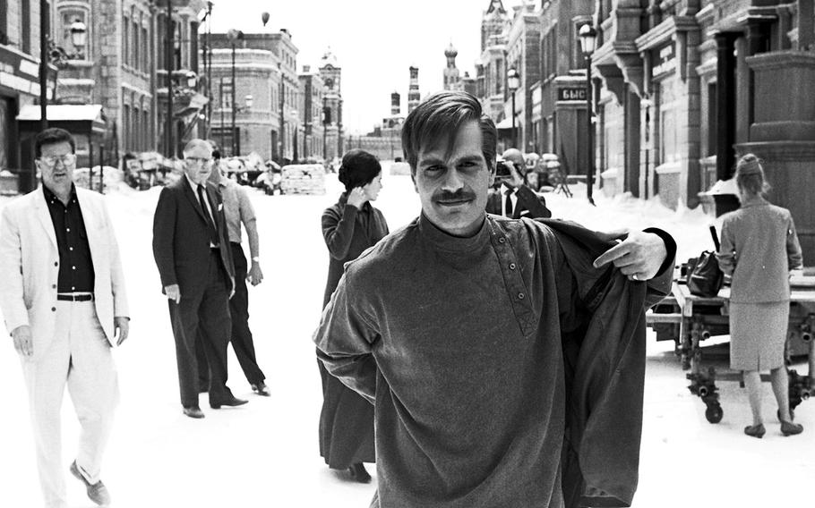 Omar Sharif takes off his coat after a "winter" scene during the filming of "Dr. Zhivago" in Madrid in 1965.