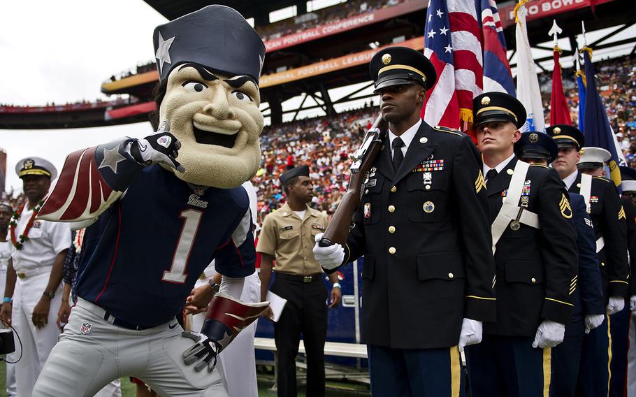 "Pat the Patriot," The New England Patriots mascot, poses for a photo with a joint service color guard prior to the beginning of the 2013 National Football League Pro Bowl. Several hundred service members assigned to bases throughout Hawaii were honored during the 2013 Pro Bowl opening ceremonies and halftime show. 