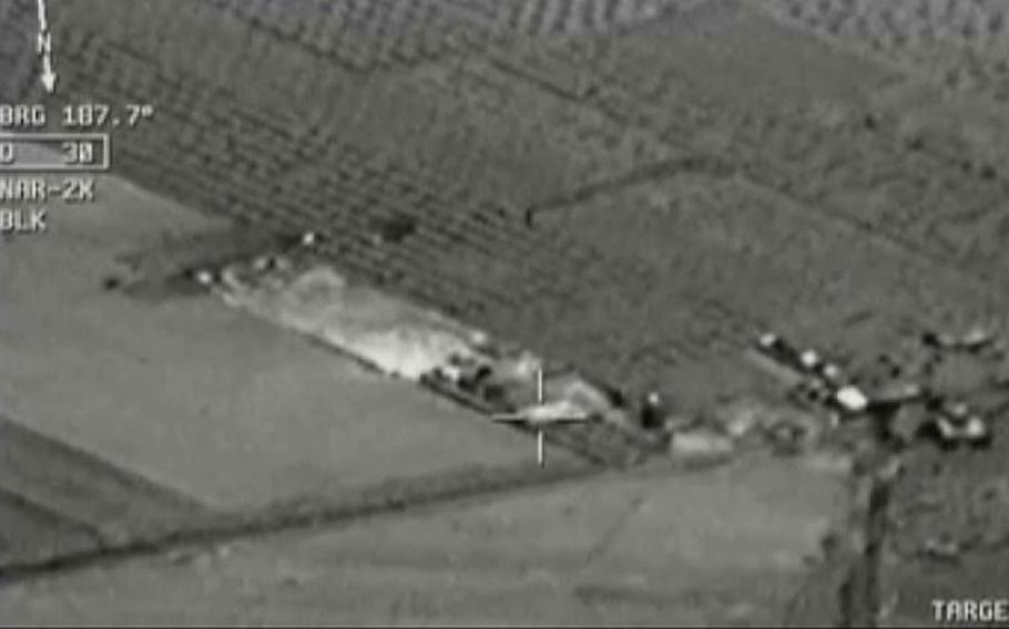 Image from aircraft cockpit video released by Turkey's state-run agency Anadolu Friday, July 24, 2015, of what they report to be Turkish warplanes striking Islamic State group targets across the border in Syria. Black object at centre above target is bomb shortly before impact. Earlier a government official said three F-16 jets took off from Diyarbakir airbase in southeast Turkey early Friday and used smart bombs to hit three IS targets across the Turkish border province from Kilis. The official, who spoke on condition of anonymity because of government rules requiring prior authorisation for comment, said the targets were two command centres and a gathering point of IS supporters. The official said the Turkish planes had not violated Syrian airspace.