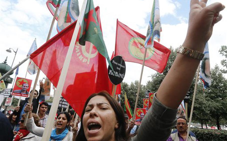 Kurdish demonstrators protest near Turkish Embassy  in Paris, France, Monday, July 27, 2015, denouncing the deaths of 32 people in a suicide bombing last Monday, in Suruc, southeastern Turkey. Turkish warplanes struck Islamic State group targets across the border in Syria early Friday, in a strong tactical shift for Turkey which had long been reluctant to join the U.S.-led coalition against the extremist group. 