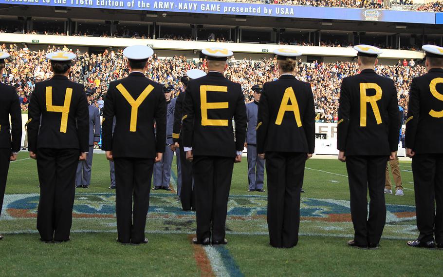 Navy midshipmen spell out their prediction for what the length of their team's winning streak over Army would be at the end of the day before the 116th Army-Navy football game, Dec. 12, 2015 at Philadelphia. Navy won, 21-17.