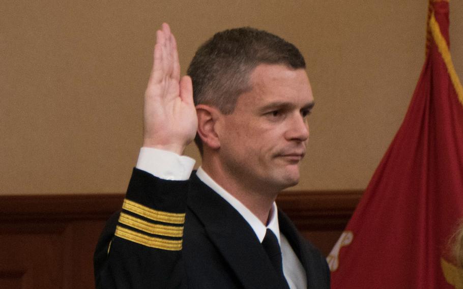 Cmdr. Aaron Rugh is sworn into the Navy and Marine Court of Criminal Appeals (NMCCA) during an investiture ceremony at the Washington Navy Yard on Oct. 28, 2015.
