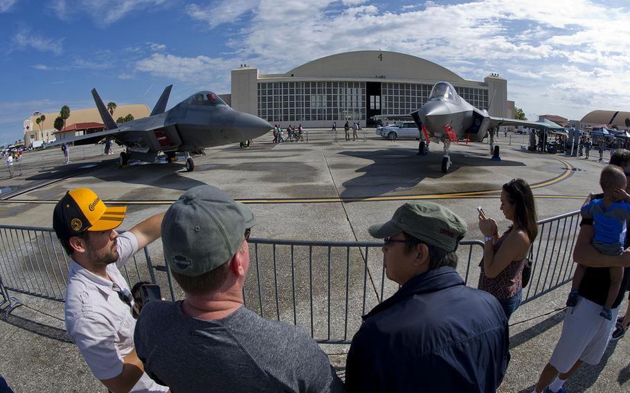 Attendees of the Tampa Bay AirFest 2016 talk about the F-22 Raptor and F-35 Lightning II at MacDill Air Force Base, Fla., March 20, 2016. 