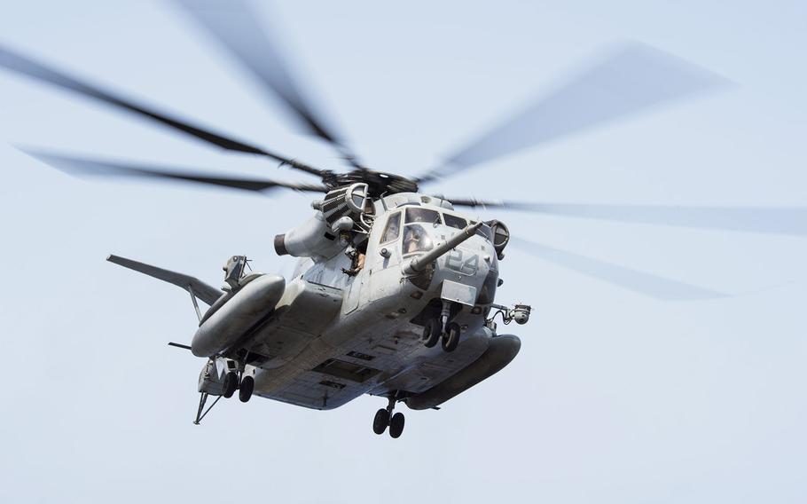 A CH-53S Super Stallion, assigned to the 13th Marine Expeditionary Unit, hovers above amphibious assault ship USS Boxer. 