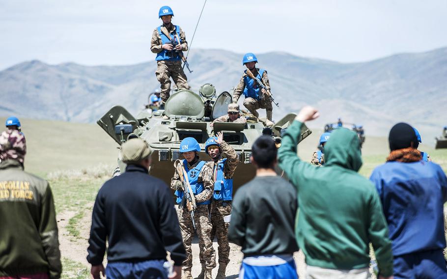 Mongolian Armed Forces prepare to communicate with an angry mob.  