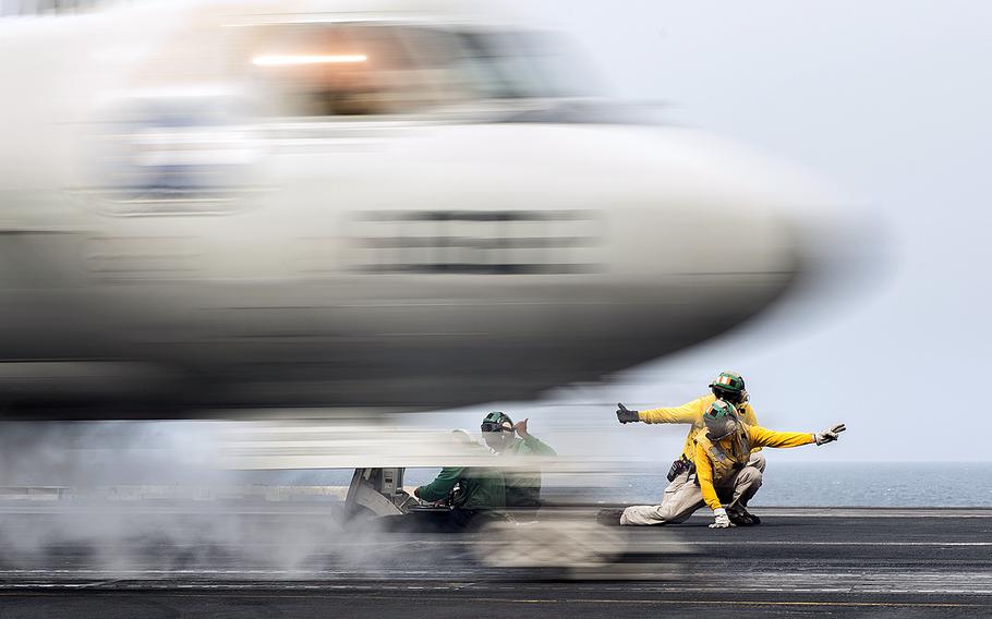 Sailors signal the launch of an E-2C Hawkeye from the flight deck of the aircraft carrier USS Harry S. Truman on April 13, 2016. Airstrikes against Islamic State militants were launched Friday, June 3, 2016, from the Truman while it was operating in the Eastern Mediterranean, according to the European Command.