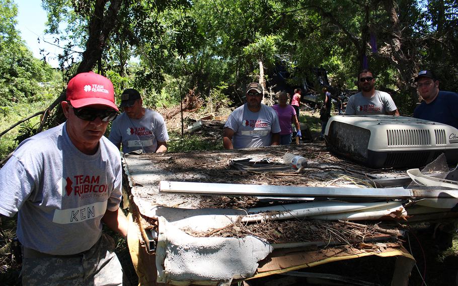Volunteers with Team Rubicon haul away debris following recent flooding in Bandera, Texas, on June 6, 2016.
