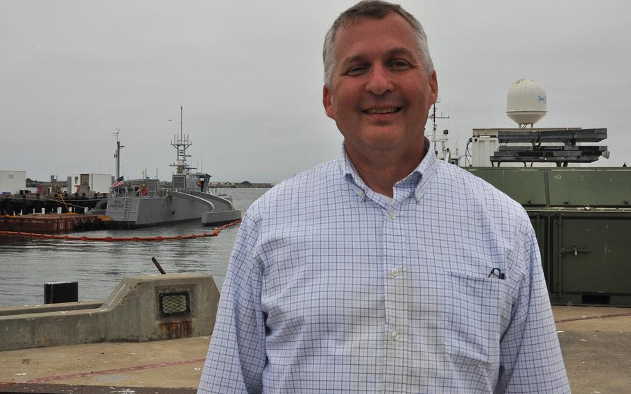 Program director Scott Littlefield stands in front of the Navy's largest unmanned vessel prototype, the Sea Hunter, at the pier in San Diego where it will undergo testing for the next two years. 