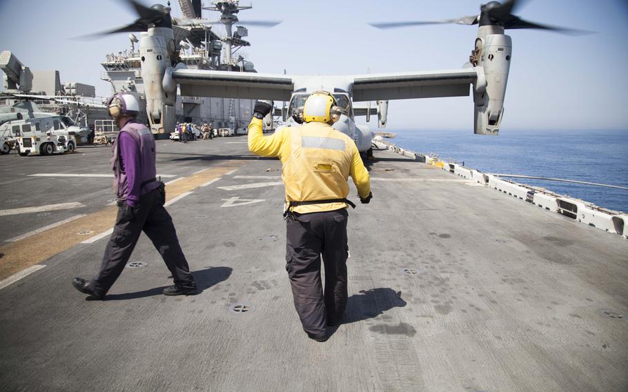 Flight deck crew personnel use hand signals to communicate with air crews and other flight deck personnel to ensure safety during flight operations on the amphibious assault ship USS Boxer on Thursday, June 16, 2016.  