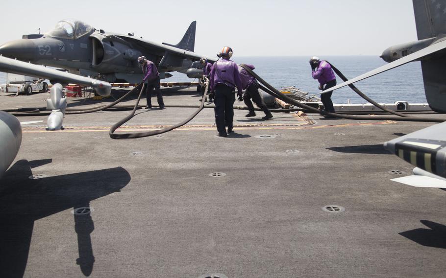 Refuelers on the deck of the amphibious assault ship USS Boxer on Thursday, June 16, 2016. The 13th Marine Expeditionary Unit's AV-8BII Harriers launched from the ship to conduct sorties against the Islamic State group. 

