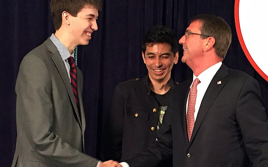 Secretary of Defense Ash Carter on Friday, June 17, 2016, congratulates 18-year-old David Dworken, left, and Craig Arendt, 35, for finding six vulnerabilities in DODs websites during the department's "Hack the Pentagon" competition.
