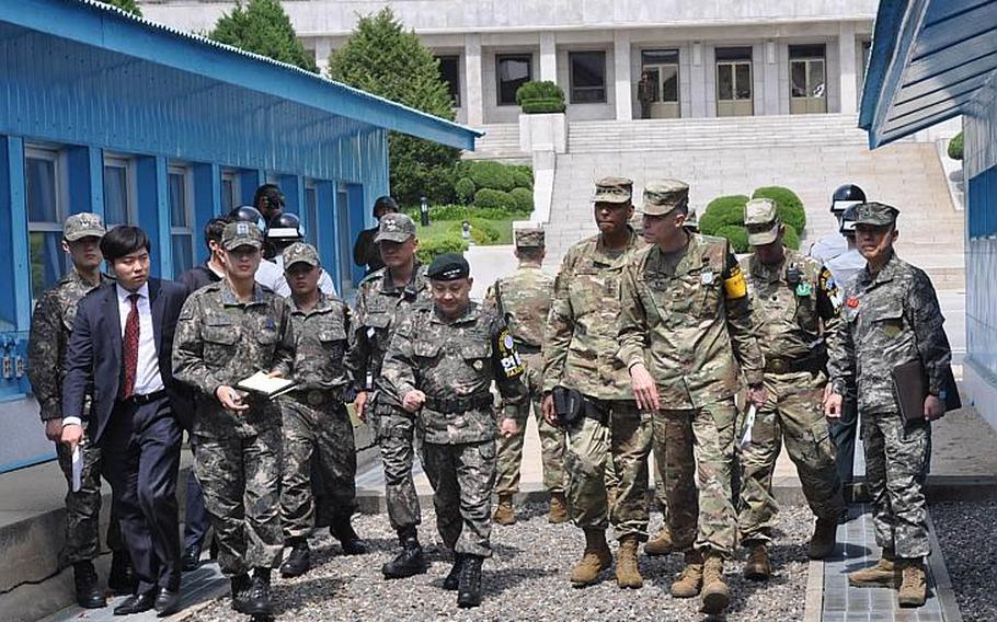 Gen. Vincent Brooks, U.S. Forces Korea commander, and Gen. Lee Soon-jim, of the South Korean joint chiefs of staff, receive a briefing at the Joint Security Area of the Demilitarized Zone Thursday, May 12, 2016. The South Korean government reported Monday that U.S. bases and a South Korean civilian appeared on a list of targets circulated by pro-Islamic State hackers.