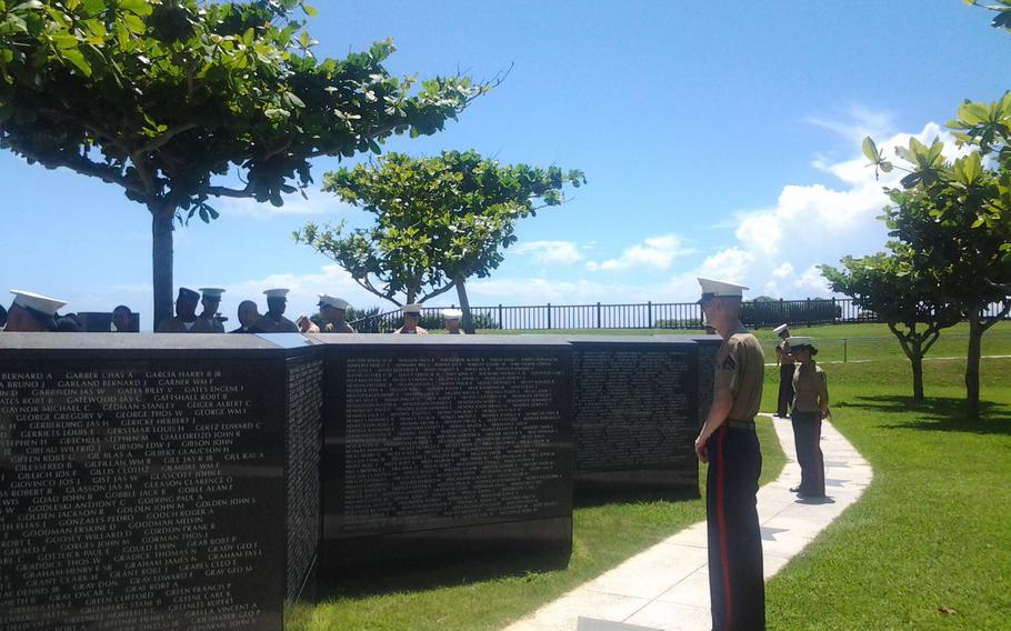 Marine Cpl. Brent Haffey of Kansas, assigned to Marine Corps Air Station Futenma, pauses a moment Thursday, June 23, 2016, at a memorial inscribed with U.S. servicemembers who died in the Battle of Okinawa in 1945. Haffey was among about 50 American and Japanese people who took part in a ceremony to remember those who fell in the battle on Okinawa 71 years ago.