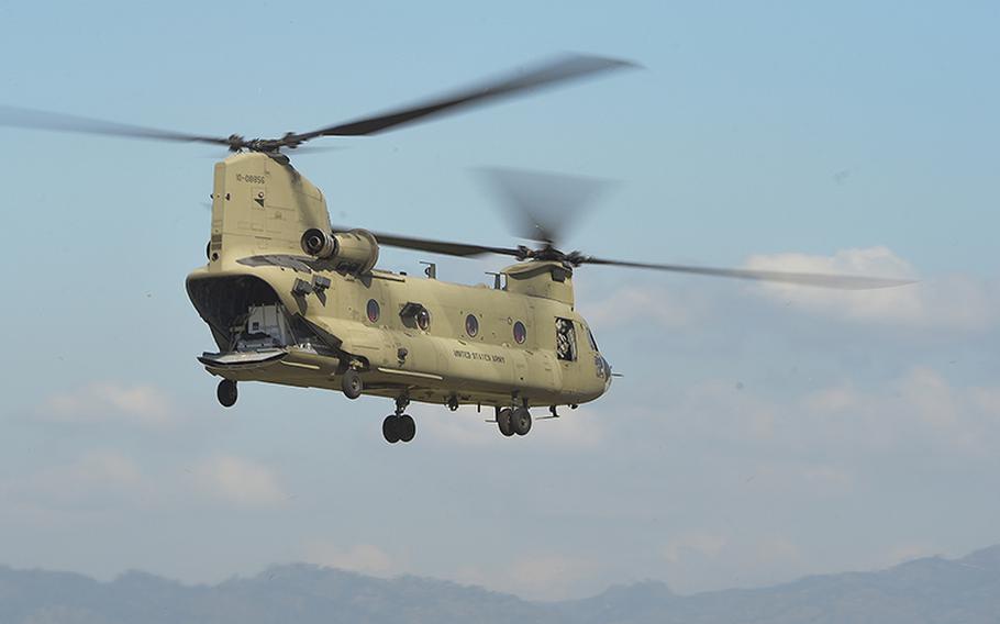 A CH-47 Chinook helicopter launches from Soto Cano Air Base, Honduras, Oct. 4, 2016, to stage at the Grand Cayman Islands in the event that air support is requested for hurricane relief efforts.