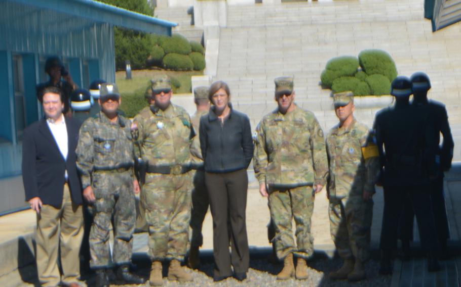 Samantha Power, the U.S. ambassador to the United Nations, center, stands with U.S. soldiers at the military demarcation line during a visit Sunday, Oct. 9, 2016, to South Korea's side of the Joint Security Area at the truce village of Panmunjom. 