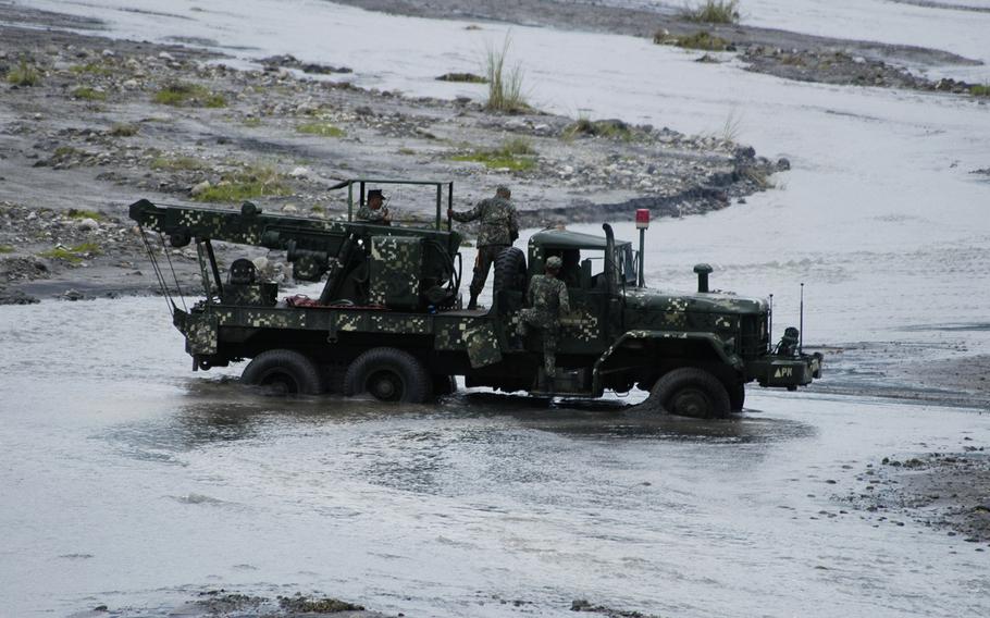  A Philippines Marine Corps truck gets stuck in a river at Crow Valley, Philippines on Monday.