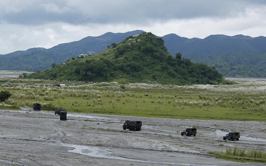 A convoy of U.S. and Philippines marines moves through Crow Valley, Philippines on Monday.