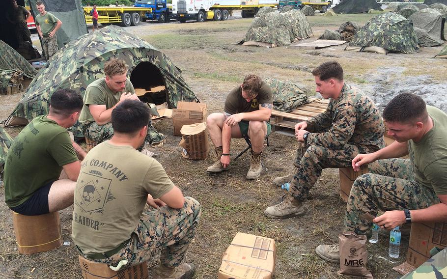 Marines eat field rations in a camp in Crow Valley, Philippines Monday. 