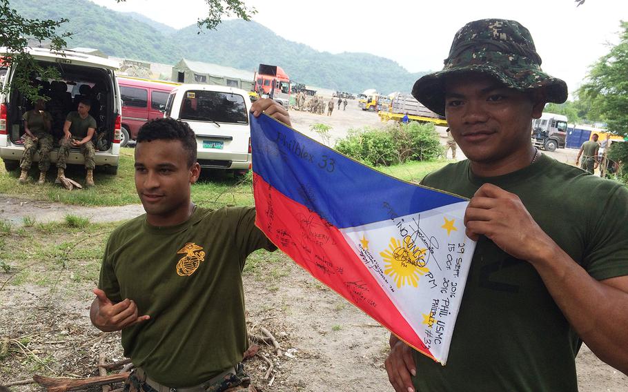 U.S. and Philippines marines have been signing flags to keep as souvenirs of their time training together this week in Crow Valley, Philippines Monday.