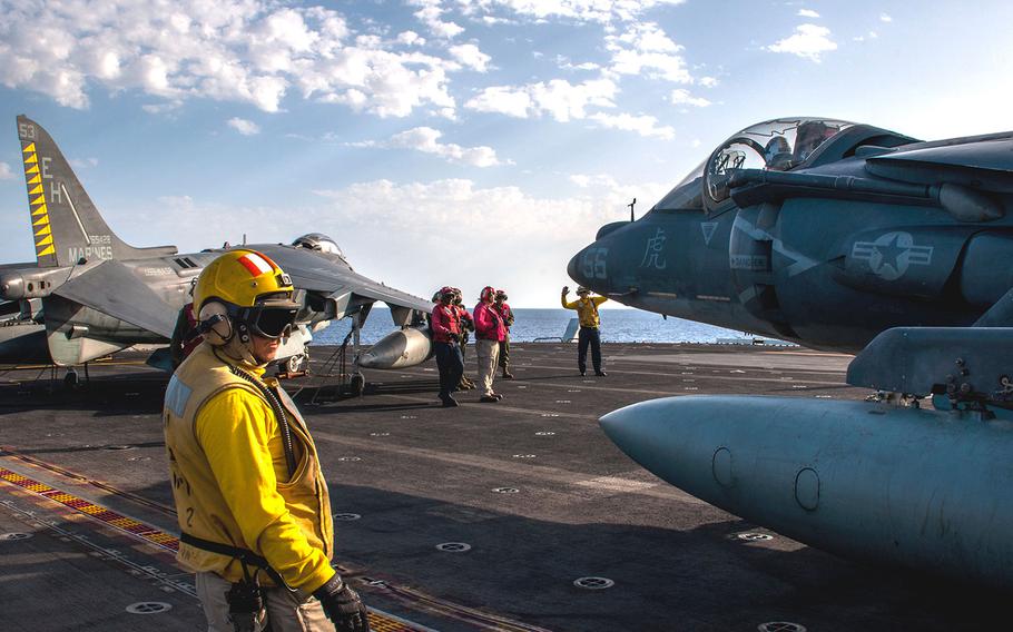 Sailors maneuver an AV-8B Harrier, from the 22nd Marine Expeditionary Unit, on the flight deck of the amphibious assault ship USS Wasp on Sept. 21, 2016. 